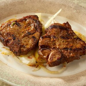 T-Bone Lamb Chops on Onion Catering Mediterranean Cuisine Minneapolis